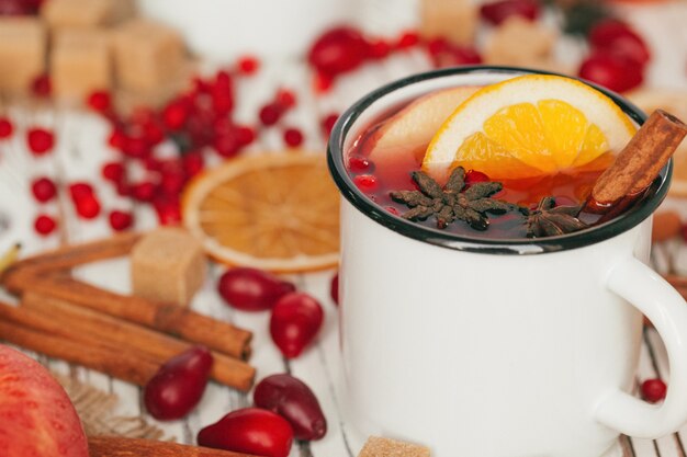 Christmas hot mulled wine in rustic cup close up