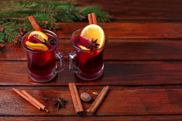 Christmas hot mulled wine with cinnamon cardamom and anise on wood