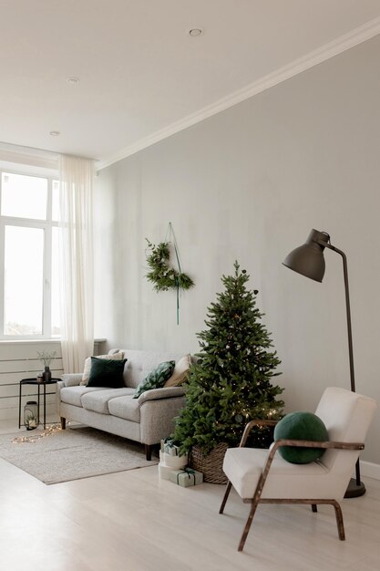 Christmas interior in scandinavian style with a sofa wreath chair and Christmas tree