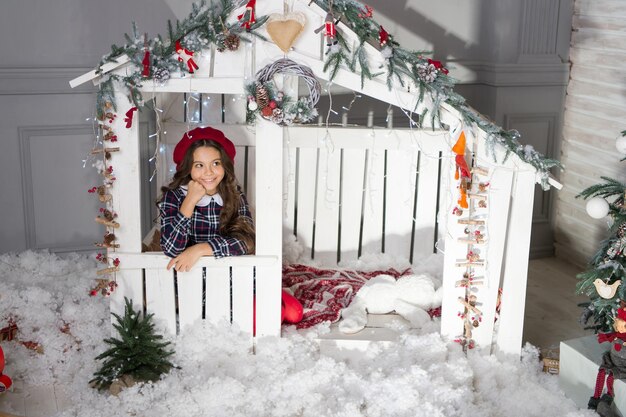 Christmas is here kid in french beret child enjoy christmas\
composition happy childhood decorate home with xmas decor new year\
celebration wait for santa winter holiday and vacation