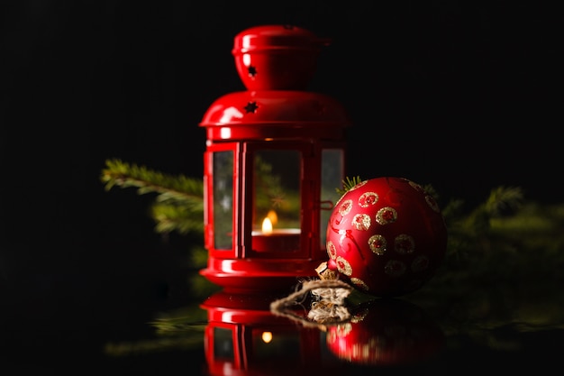 Christmas lantern in night on old wooden table. focus on the wick candles