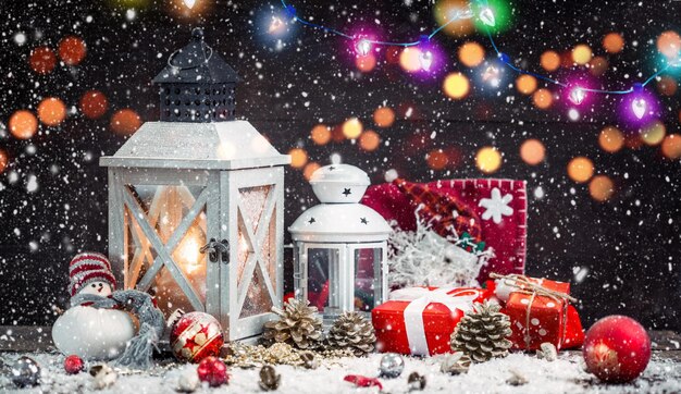 Christmas Lantern on snowy table with festive decoration.