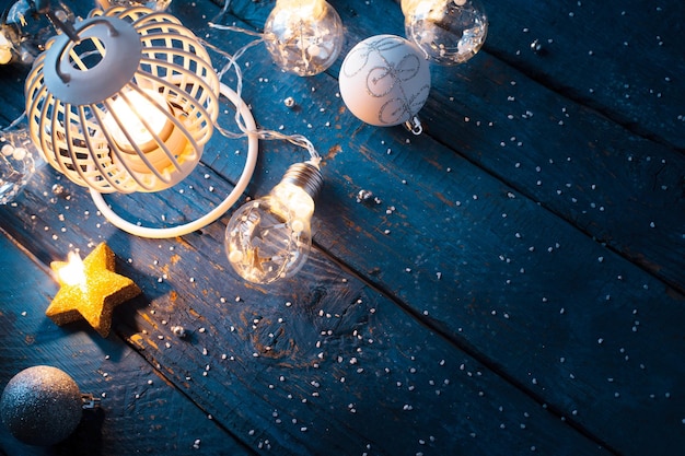 Christmas lantern with decoration on blue wooden background