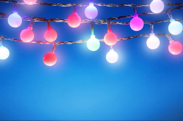 Christmas lights on color background