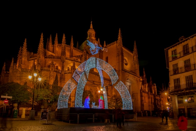 Christmas lights and decorations adorn the square of cathedral in Segovia