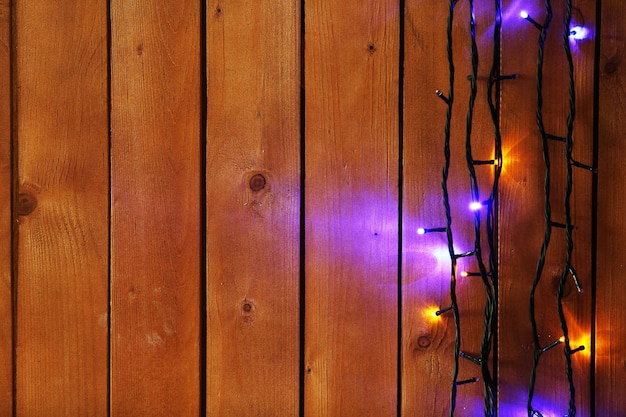 Christmas lights garland on wooden background