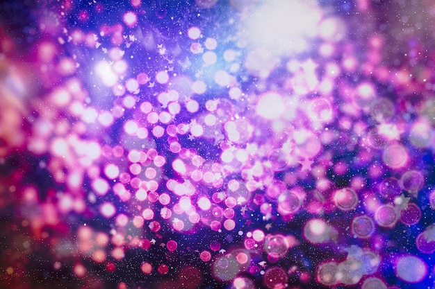 Photo christmas lights. gold holiday new year abstract glitter defocused background with blinking stars and sparks.