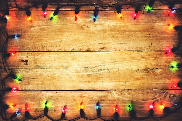 Christmas lights. Merry christmas (xmas) background. Old wood texture - vintage background 