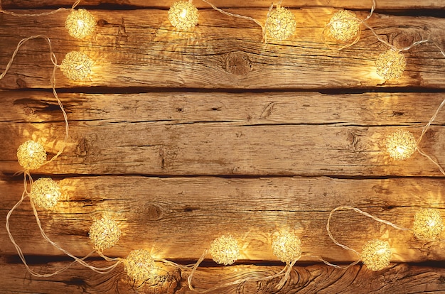 Christmas lights on a wooden background with copy space