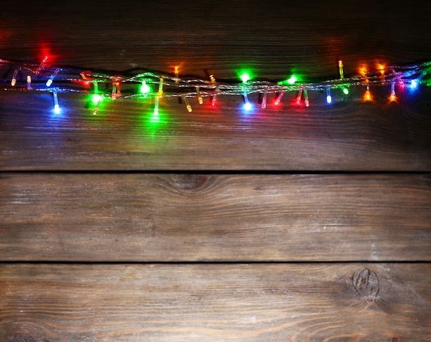 Christmas lights on wooden background