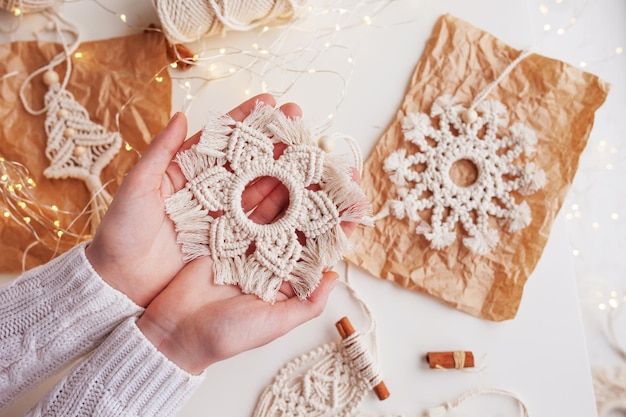 Christmas macrame decor christmas toy in woman hand natural
materials cotton thread wood beads and stick eco decorations
ornaments hand made decor winter and new year holidays