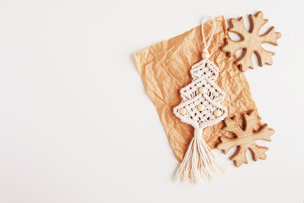 Christmas macrame eco decor Christmas tree and wooden snowflakes on craft paperecorations ornam