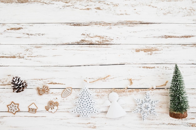 Christmas miniature tree, Xmas decoration and ornament on white wood background. vintage style, top view.