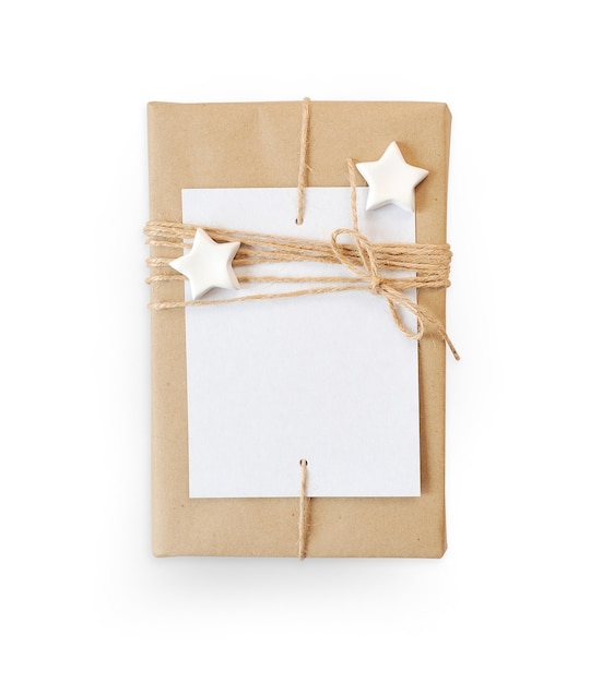 Christmas mockup Gift box wrapped in brown recycled paper and star rope top view isolated on white background