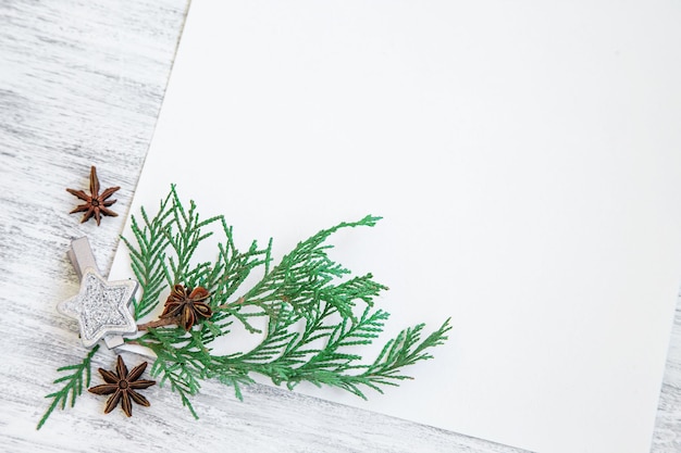 Photo christmas mockup with pine branches on white paper