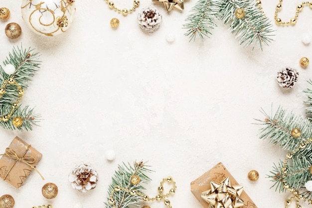 Christmas mood frame of gifts, spruce and gold decorations on white space.