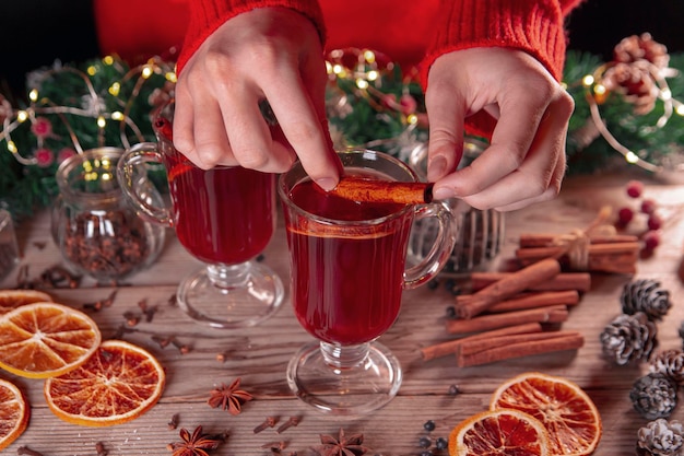 Christmas mood holiday atmosphere The girl prepares mulled wine on a wooden table