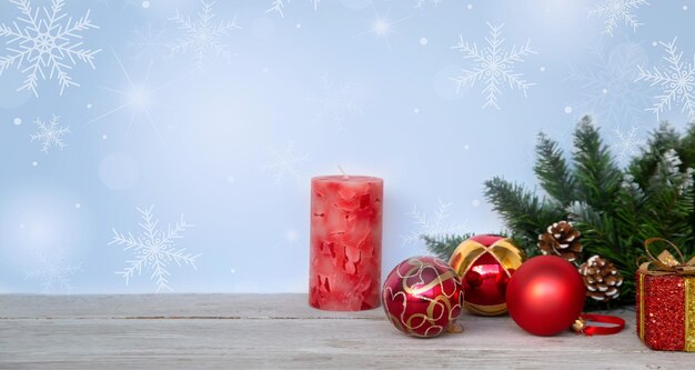 Christmas mood new year background christmas fir branches red\
christmas balls a candle and gift boxes on a background of\
hoarfrost patterns with copy space holiday atmosphere