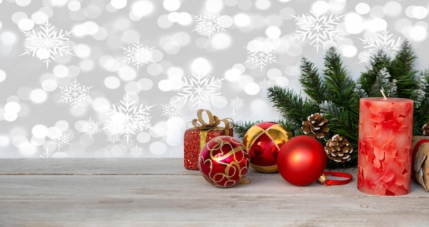 Umore natalizio nuovo anno sfondo albero di natale rami rossi palle di natale una candela e un regalo