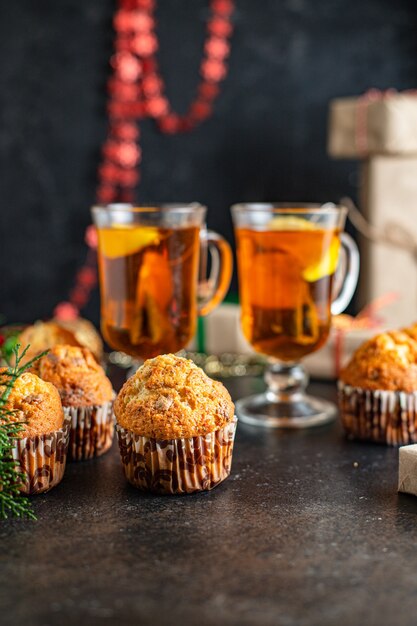 christmas muffins with decorations on black table