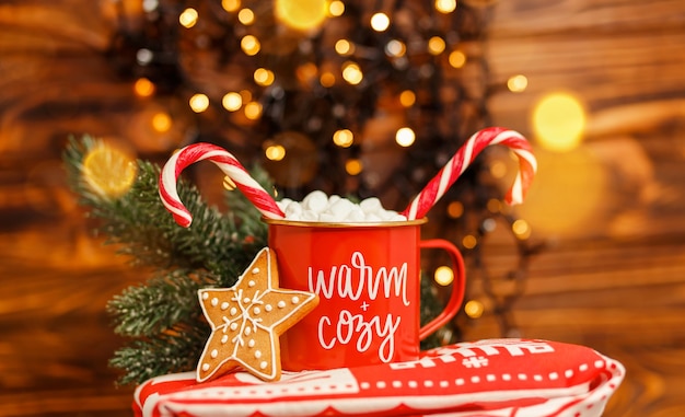 Christmas mug with hot drink and candy cane festive bokeh