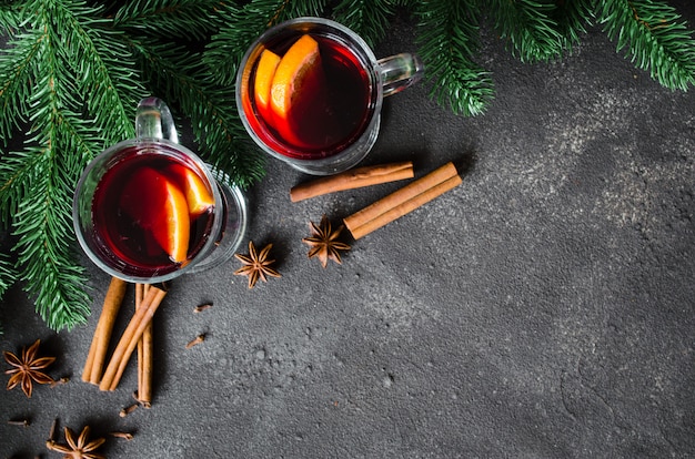 Christmas mulled red wine with spices on dark background