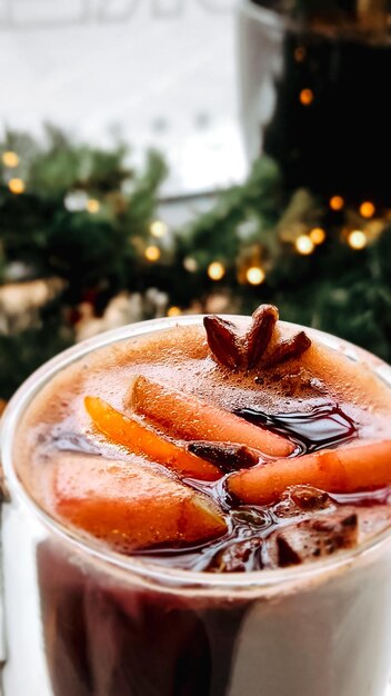 Christmas mulled wine on blurred background of bright lights traditional new years hot drink made