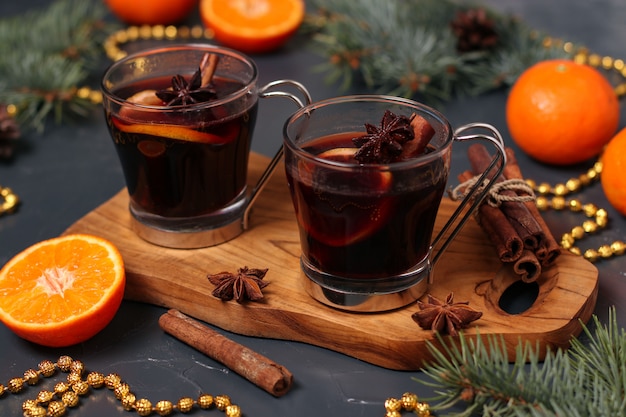 Christmas mulled wine and tangerines on a dark background