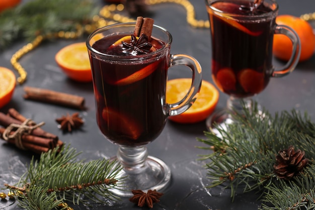 Christmas mulled wine and tangerines on a dark surface, horizontal orientation