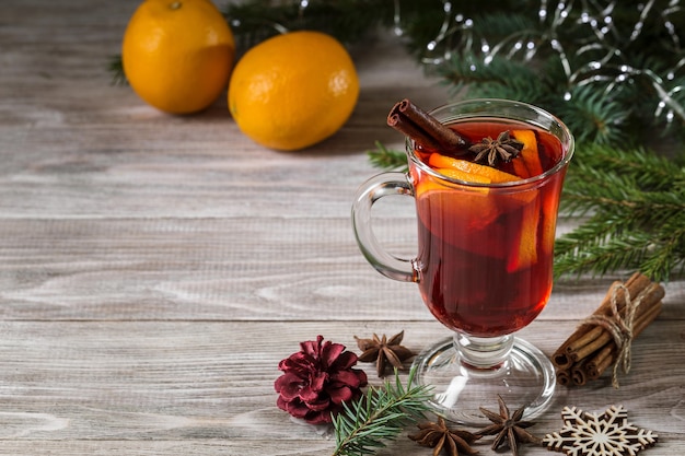 Christmas mulled wine and tangerines with cinnamon sticks