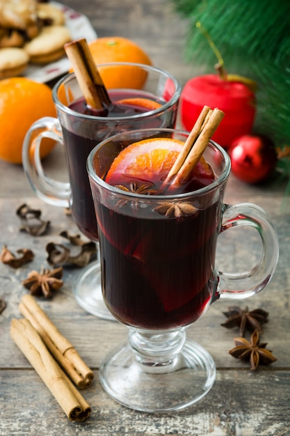 Christmas mulled wine in typical glass on wooden table