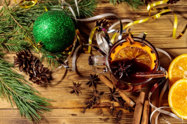Christmas mulled wine with spices and Christmas decoration on wooden table. Top view