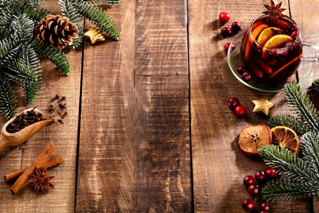 Christmas mulled wine with spices on a wooden rustic table.