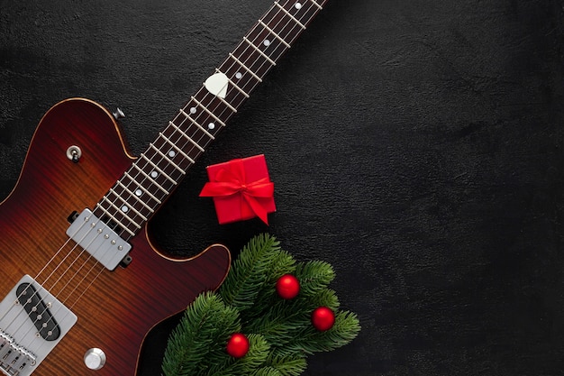 Christmas music composition with guitar and fir tree branches