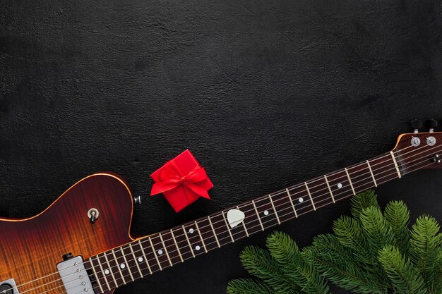 Christmas music composition with guitar and fir tree branches