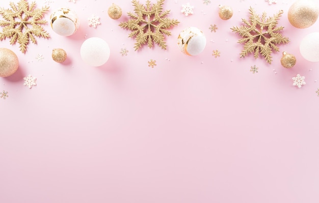 Christmas and new year background concept Top view of Christmas ball star and snowflake on pastel pink background