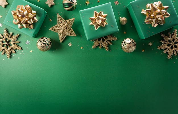 Christmas and new year background concept. top view of christmas gift box, christmas ball and snowflake on green background