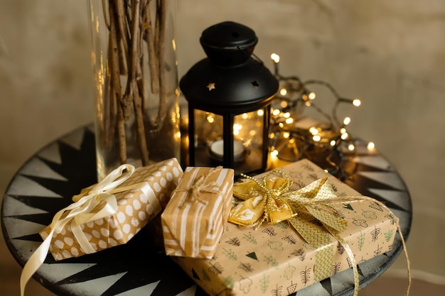 Christmas and New Year background gift boxes near a decorated Christmas tree with garlands of lights