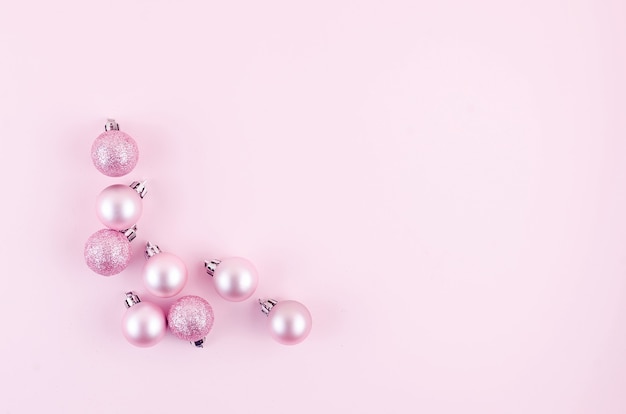 Christmas or New Year background. pink christmas balls  on pastel pink background. Christmas holiday concept. Flat lay, top view, copy space