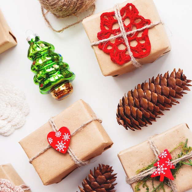 Christmas and New Year background with handmade presents wrapped in craft paper and decorations.