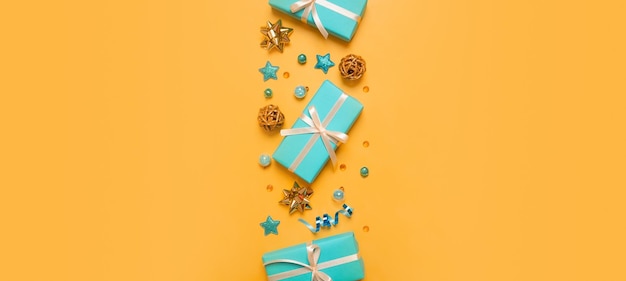 Christmas and New Year banner with gift boxes and decorations on colored background top view flat lay