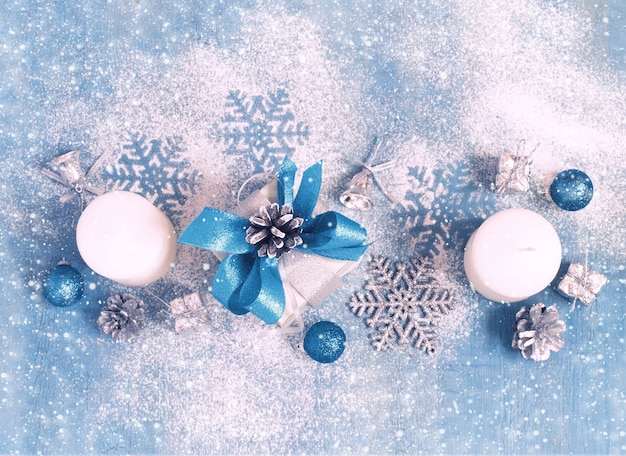 New year theme: Christmas tree white and silver decorations, blue balls,  snow, snowflakes, serpentine on white retro stylized wood background  contrasted Stock Photo by ©BoxerX 90908586