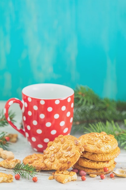 Christmas and New Year composition with delicious peanut cookies peanuts and cup of coffee or tea
