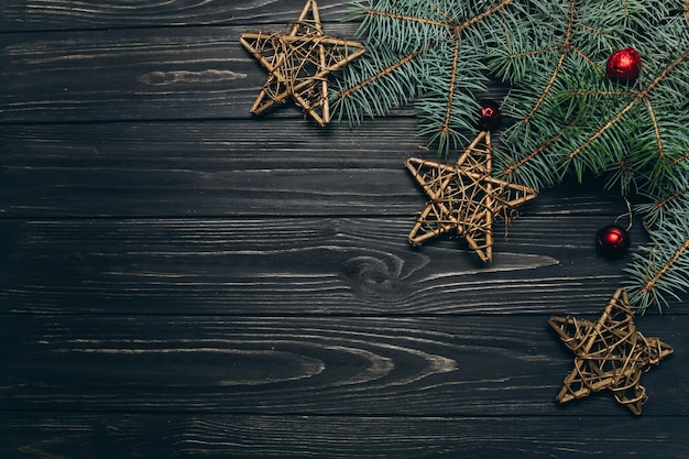 Christmas or New Year dark wooden background, Xmas black board framed with season decorations.