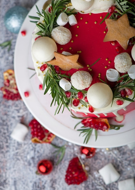 Christmas or New Year decorated cake with cream cheese frosting and cranberries, selective focus