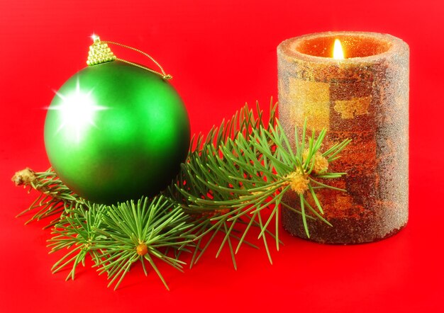 Christmas and New Year decoration-balls and candels on red background .