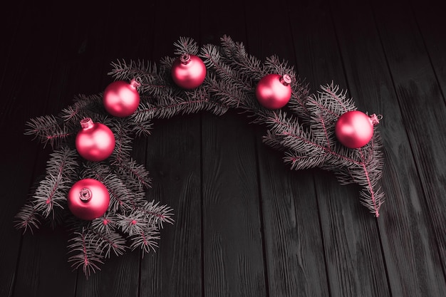 Christmas New Year decoration composition Top view of furtree branches and balls frame on wooden background with place for your text close up Fresh classic 2023 in blue Color concept of the year