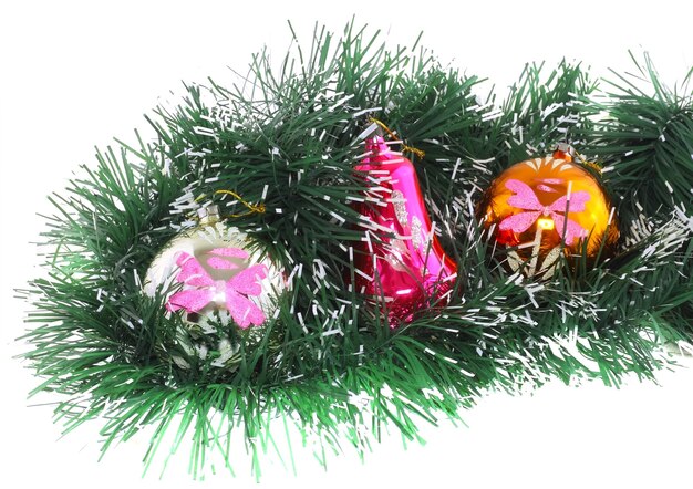 Christmas and New Year decoration- glass balls, green tinsel . Close-Up. On white background, isolated.