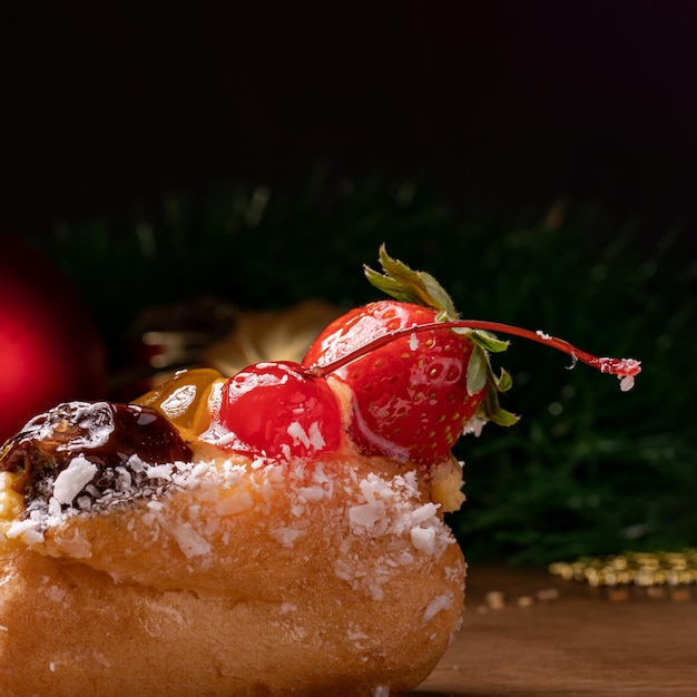 Christmas and New Year decoration, with sweets covered with strawberry and cherry. Ideal for background with copy space. Selective focus.