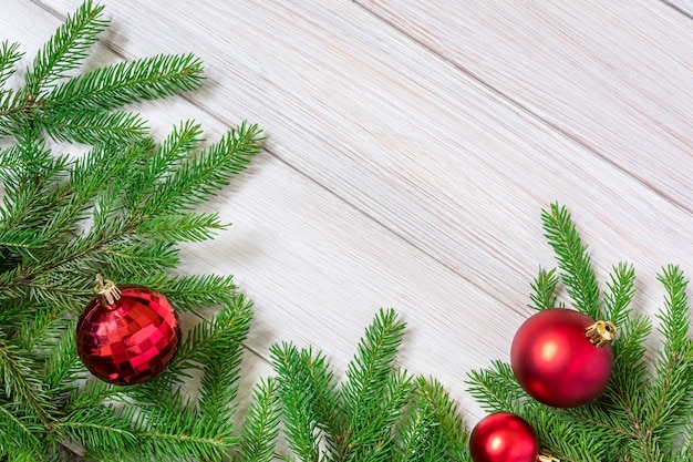 Christmas or new year decorations background - fir branches and red Christmas toys in  form of balls